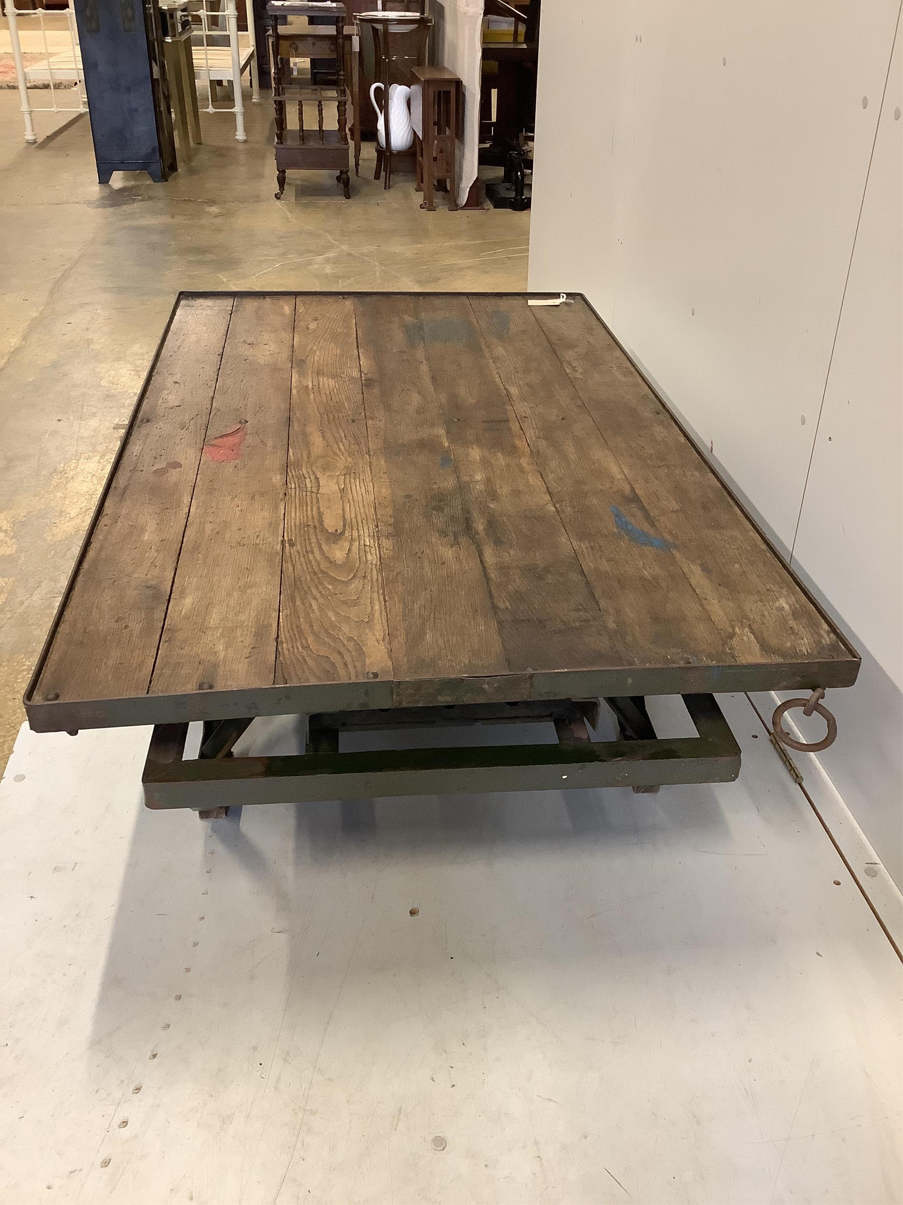 An Industrial style cast iron and planked oak coffee table converted from a Second War British military turntable, width 152cm, depth 92cm, height 38cm. Condition - good.